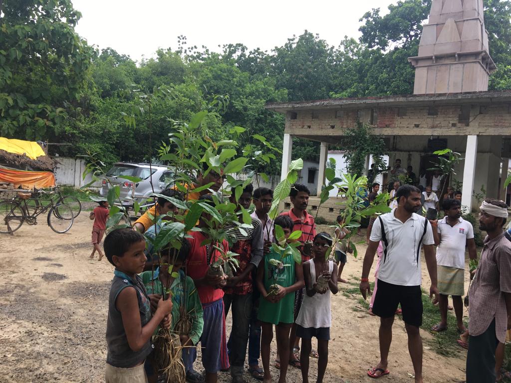 Youngsters with tree saplings